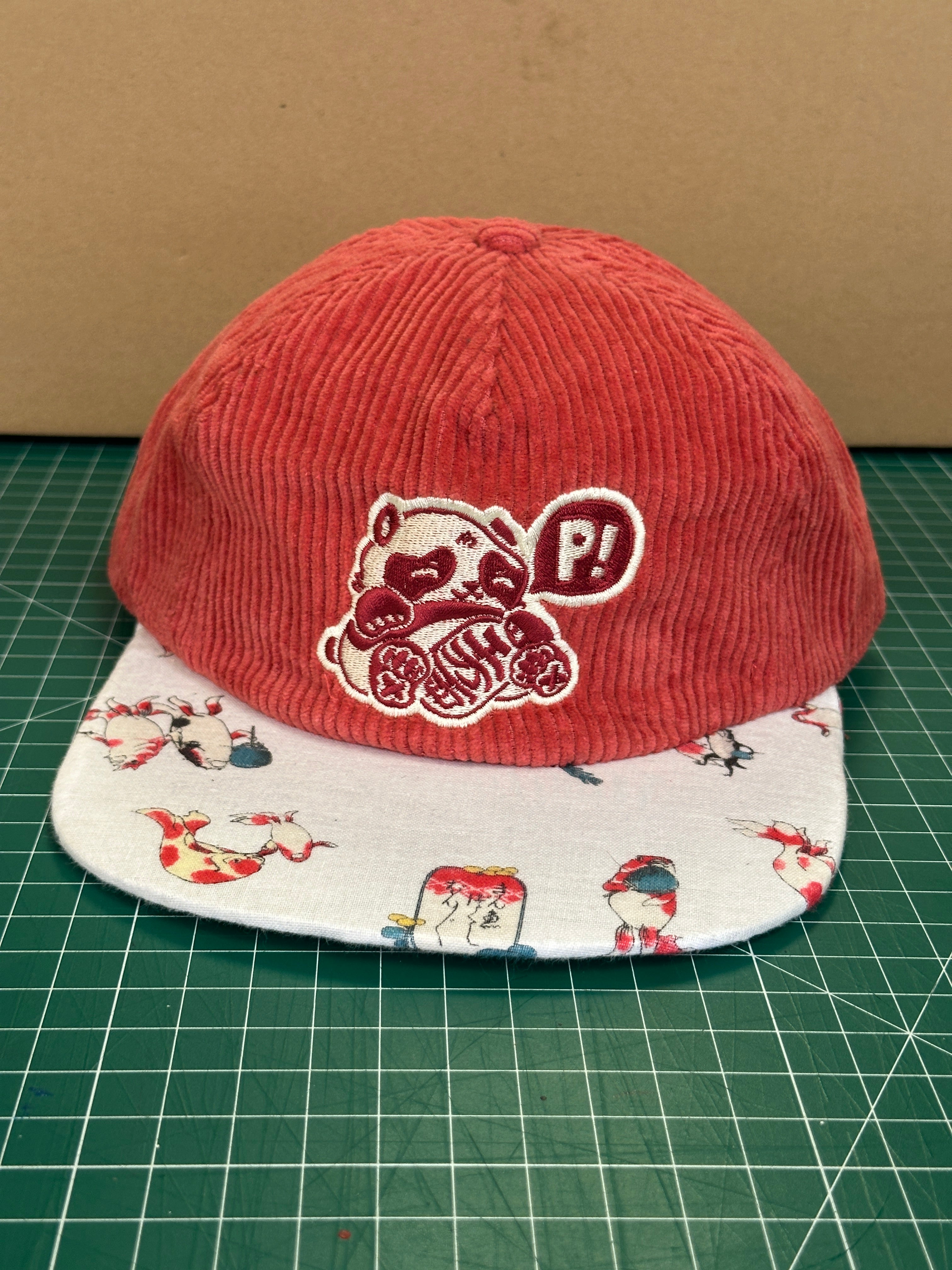 Salmon corduroy branded basics with Koi brim 1 of 1